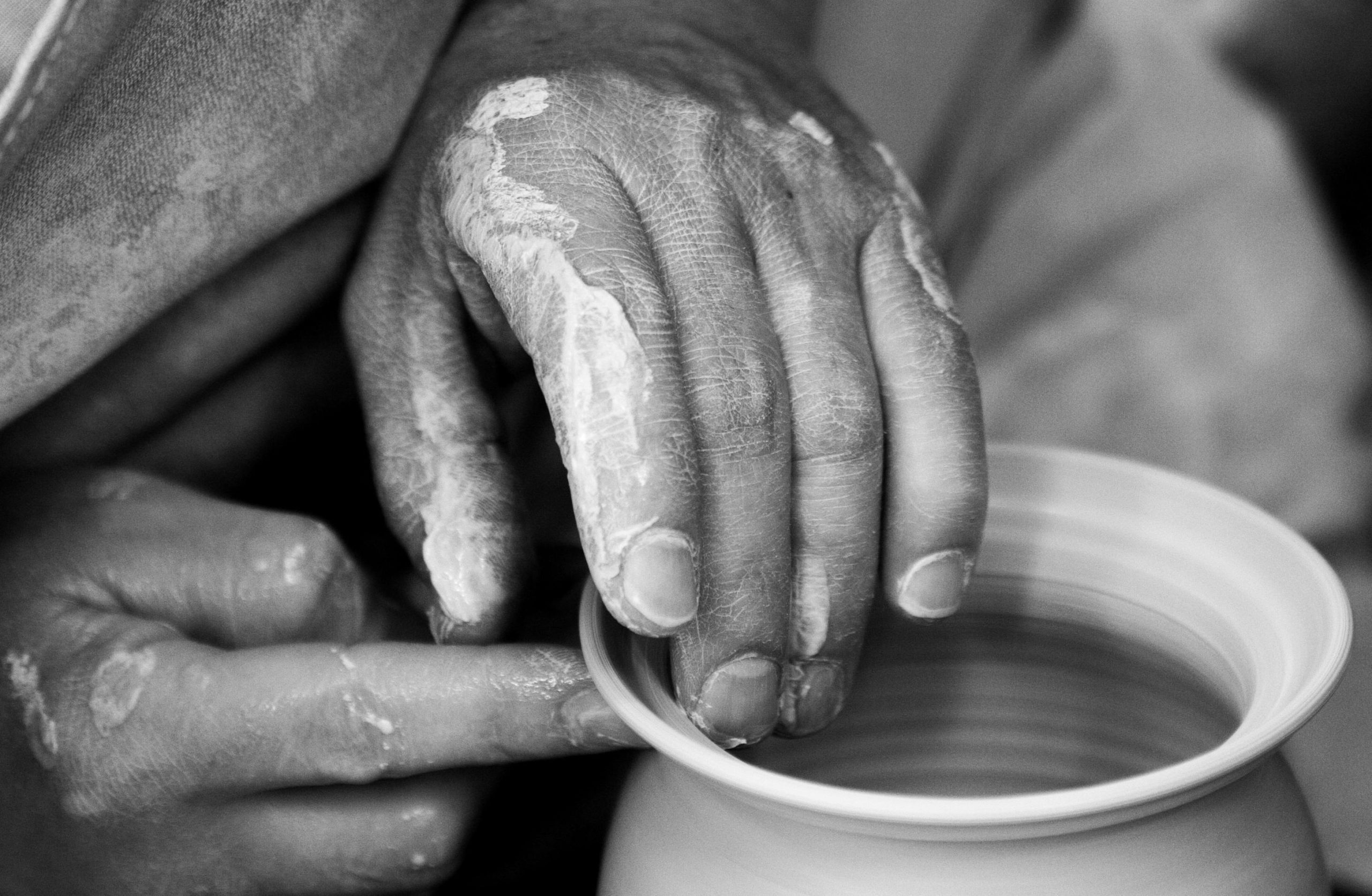 pottery wheel,hands shaping clay